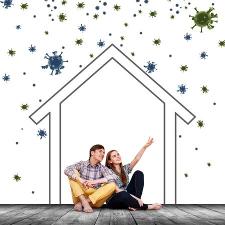 Couple sitting on the floor with paint home among coronavirus cells.の写真素材