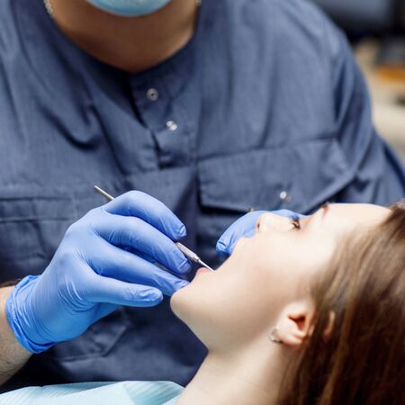 Dentist check-up teeth to young woman patient.の写真素材