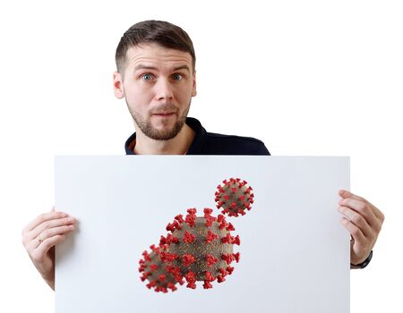 Surprised man holds white placard with coronavirus cell.の写真素材