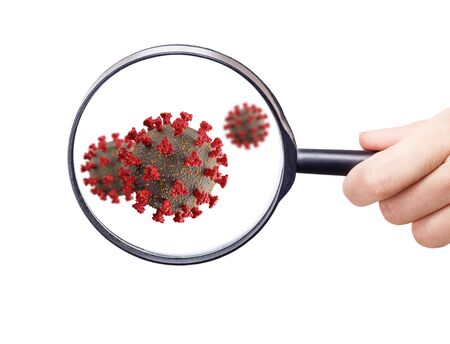 Magnifying glass shows coronovirus cells.の写真素材