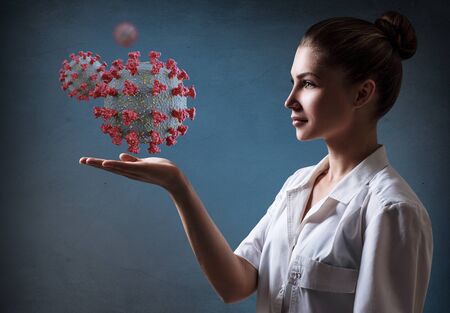 Female doctor presents viral cell coronavirus.の写真素材