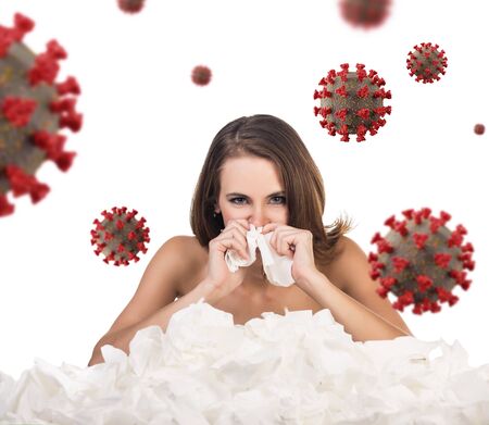 Young woman with a lot of hankys among coronavirus cells.の写真素材