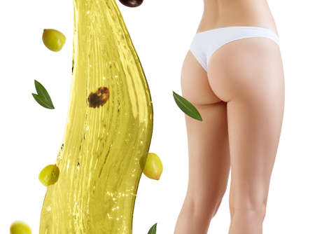 Female buttocks near olive oil splash. Slimming and dieting concept. Over white background.の写真素材