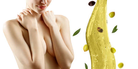 Young beautiful woman near splash of olive oil. Skincare concept. Isolated on white background.の写真素材