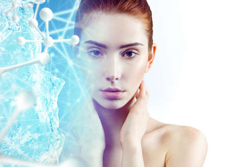 Beautiful ginger woman near big white molecules.の写真素材