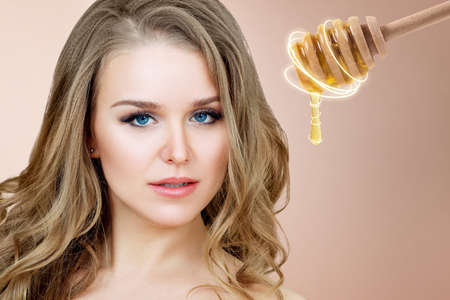 Adult woman and honey spoon prepare for facial mask.の写真素材