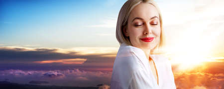 Beautiful woman over beautiful colorful sunset.の写真素材