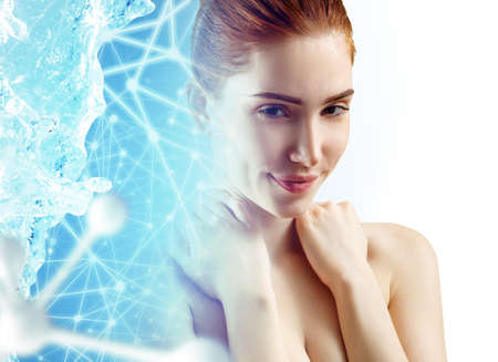 Ginger woman near big white molecules in water splash.の写真素材