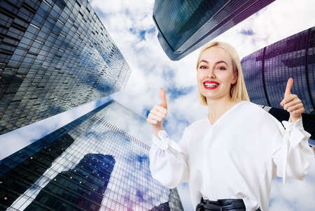 Business woman stands over cityscape background.の写真素材