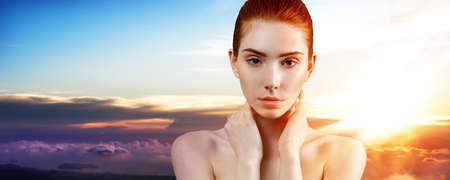 Young ginger woman over sunset.の写真素材