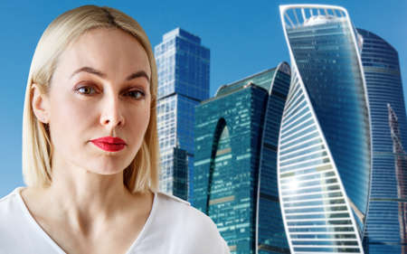 Business woman stands over cityscape background.の写真素材