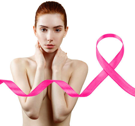 Collage of young redhead woman smiling near big pink ribbon.の写真素材