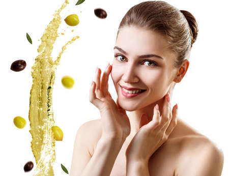 Young beautiful woman near splash olive oil.の写真素材