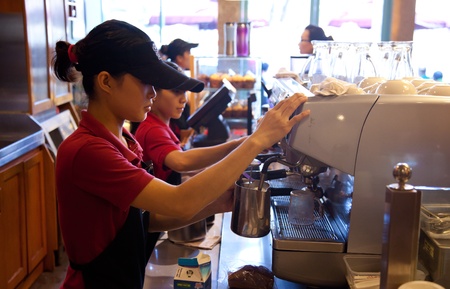 Staff at a cafe in central Ho Chi Minh City making cappuccino.のeditorial素材