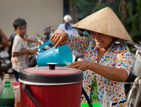 Vietnamese woman selling drinks in a market.のeditorial素材