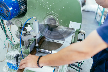 Factory for aluminum and PVC windows and doors production. Manual worker assembling PVC doors and windows.の写真素材