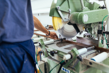 Factory for aluminum and PVC windows and doors production. Manual worker assembling PVC doors and windows.の写真素材