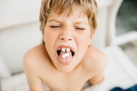 The boy holds the tablet on the tongueの写真素材