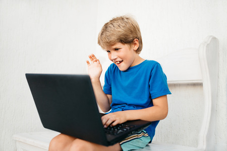 A boy chatting via laptopの写真素材