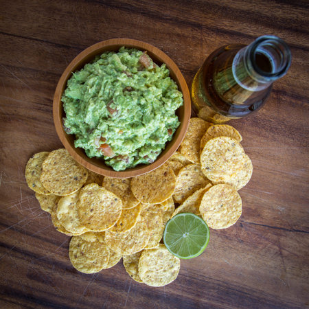Guacamole corn chips and beerの写真素材