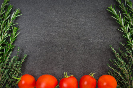 Fresh rosemary thyme herbs and tomatoesの写真素材