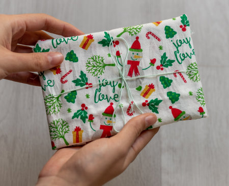 holding gift zero waste wrapped in fabricの写真素材
