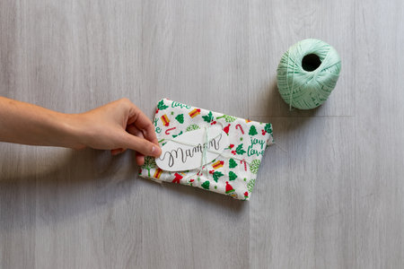 holding gift zero waste wrapped in fabricの写真素材