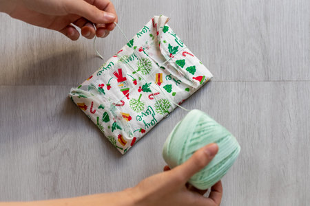 holding gift zero waste wrapped in fabricの写真素材