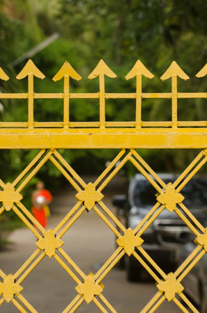 Wrought iron entrance door yellow beautiful old.の写真素材
