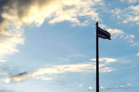 Thailand flag pole silhouette at sunset, Rain is comingの写真素材