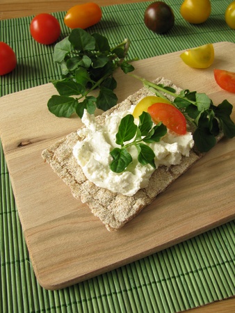 Cream cheese with watercress on crispbreadの写真素材