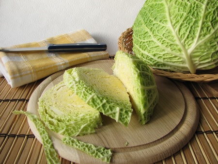 Savoy cabbage on cutting boardの写真素材