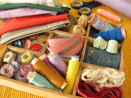 Wooden box with colored sewing utensils
