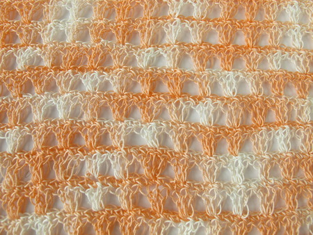 Crochet pattern background in coralの写真素材
