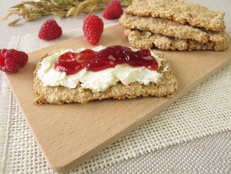 Homemade oats crispbread with raspberry jamの写真素材
