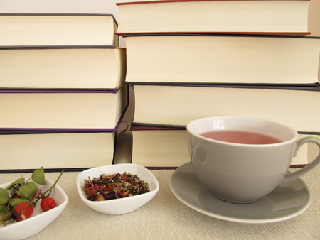 Thick books and a cup of tea for leisure timeの写真素材