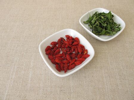 Dried goji berries and goji leavesの写真素材