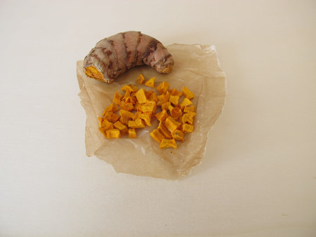 Dried turmeric, curcuma root in wax paper