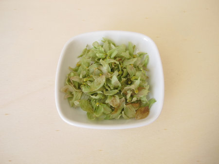Dried hop flowers on a wooden boardの写真素材