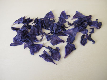 Dried mallow flowers on a wooden boardの写真素材
