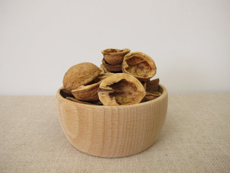 Craft material made from halved walnut shells in a wooden bowlの写真素材