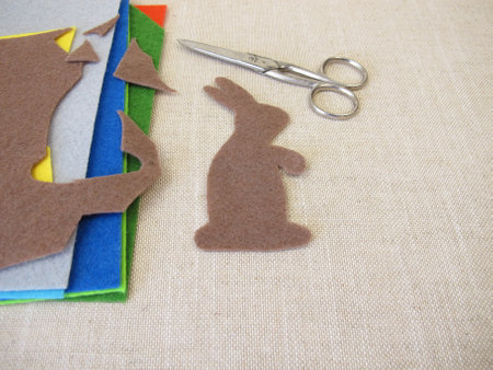 Cut out brown Easter bunny from colorful feltの写真素材