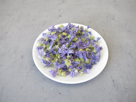 Dried mallow flowers on a small plateの写真素材