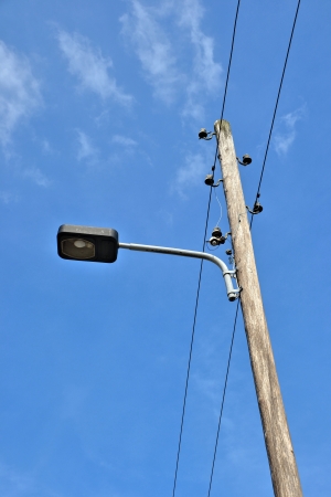 an old street lamp and power cablesの写真素材