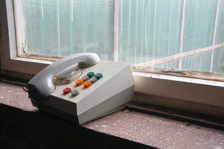old phone in an abandoned disused East German companyの写真素材