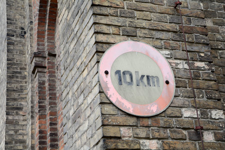 road sign with speed limit on a wall of an abandoned factory