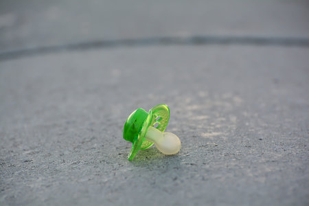 lost pacifier on a footpathの写真素材