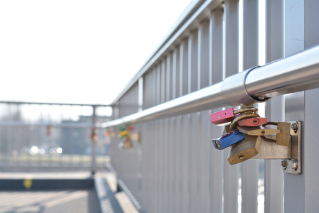 MAGDEBURG, GERMANY - MARCH 18, 2015: Padlocks as proof of love on a bridge in Magdeburgのeditorial素材