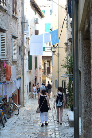 Rovinj, Croatia - July 14, 2015: Tourists in on alley of the old town of Rovinj in Croatiaのeditorial素材