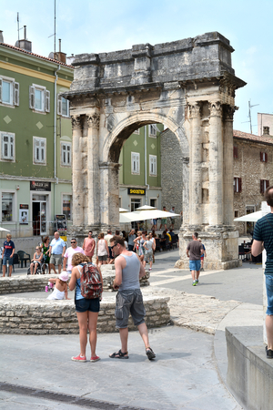 PULA, CROATIA - JULY 13, 2015: Tourists in old town of Pula on the Arch of the Sergiiのeditorial素材